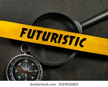 Business concept.Text FUTURISTIC writing on ice cream sticks with compass and magnifying glass on a black background.