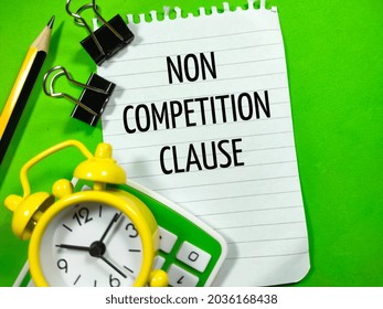 Business Concept.Text NON COMPETITION CLAUSE Writing On Notepaper With Calculator,clock,paper Clips And Pencil On Green Background.