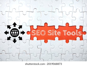 Business concept.Text SEO Site Tools with simple icon and jigsaw puzzle on red background.