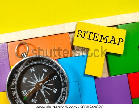 Business concept.Text SITEMAP with compass and wooden puzzle on yellow background.