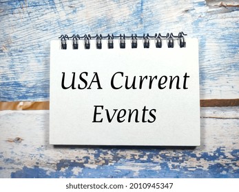 Business Concept.Text USA Current Events With Notebook On A Wooden Background.