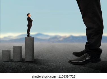 Business Concept.Tiny Businessman Looking Up On Giant Legs Of Another Businessman.Career Growth And Opportunities.a Small Business Looking Up A Big Business