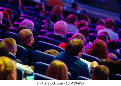 Business Conference Attendees Sit And Listen To Lecturer, Rear Top View