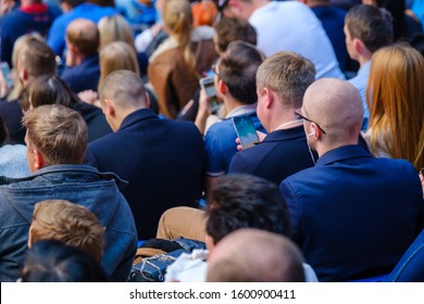 Business Conference Attendees Sit And Listen To Lecturer, Rear View