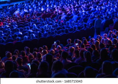 Business Conference Attendees Sit And Listen To Lecturer, Rear View