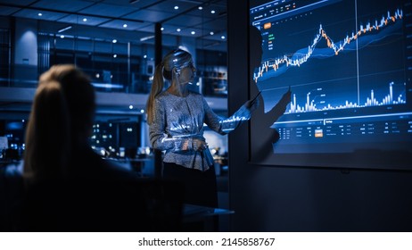 Business Conference Meeting Presentation: Businesswoman does Financial Analysis talks to Group of Businessspeople. Projector Screen Shows Stock Market Data, Investment Strategy, Revenue Growth - Powered by Shutterstock