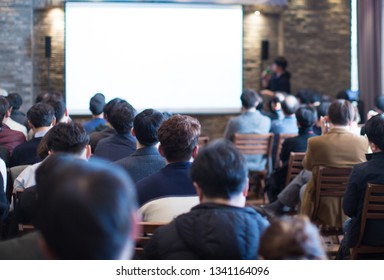 Business Conference Photo. Executive Speaker On Stage. Business Presentation Presenter Speech At Tech Entrepreneur Meeting. Corporate Event With Audience. Expert Seminar Lecture Conference Event.