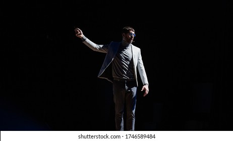 Business Conference Stage: Caucasian Visionary Startup CEO Presents New Product, Does Motivational Talk Science, Technology, Entrepreneurship, Development, Leadership. Black Background