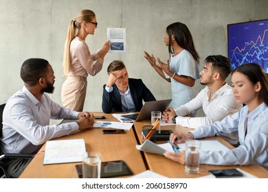 Business Conflicts. Two Female Employees Arguing During Corporate Meeting In Office, Multiethnic Group Of Business People Having Stress With New Project, Brainstorming Together In Boardroom