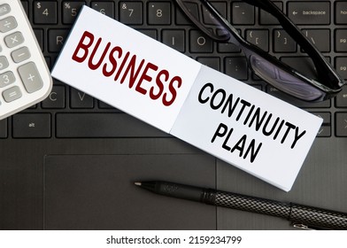 Business Continuity Plan Text On Notepad With Glasses, Pen And Laptop Background. Business Continuity Concept