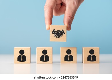 business contract. Hand putting hand shaking which print screen on wooden cube block in front of human icon for business deal and agreement concept. Teamwork process of partner and best relationship.