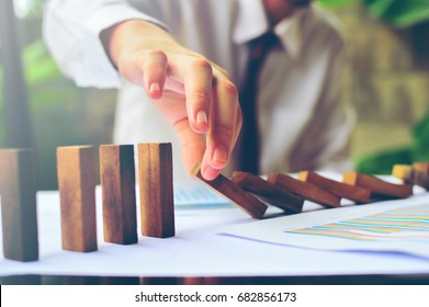 Business control concept by stopping domino effect - Shutterstock ID 682856173