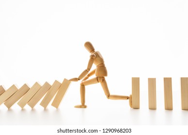 Business Control Concept. Wooden Mannequin Stopping Domino Effect On White Background, Copy Space