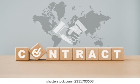 For business cooperation concept, CONTRACT ,check circle instead of O, on wooden cube blocks with check hand icon and world map  - Shutterstock ID 2311703503