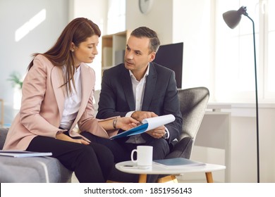 Business couple analyzing documents talking about new work project during coffee break. Man and woman office workers discussing new business ideas while sitting in the office. - Powered by Shutterstock