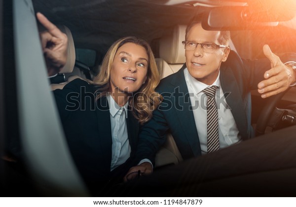 business couple in\
formal wear checking new\
car