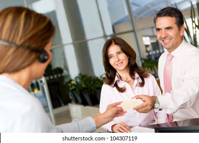 Business Couple Paying The Hotel By Credit Card