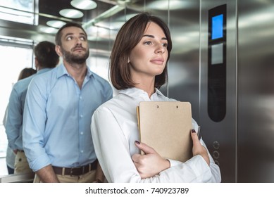 Business Couple Is Rising In Elevator