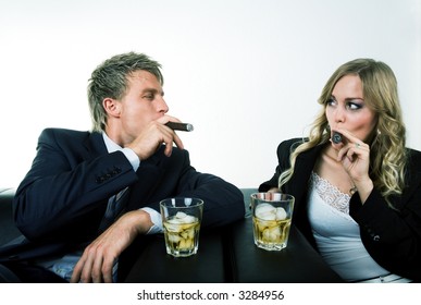 A Business Couple Smoking Cigars, Drinking Whisky, Flirting