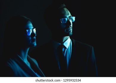 The business couple standing in the dark room