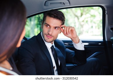 Business Couple Talking In Back Seat Of Car