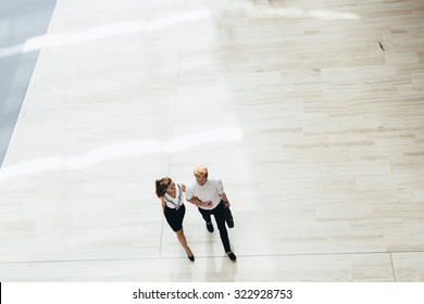 Business Couple Walking Together. Top View