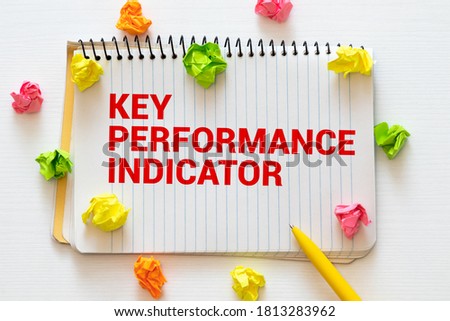 Business and creative concept,Key Performance Indicator KPI,Measure Success word on blackboard with green plant,pen and spectacle eyeglasses.