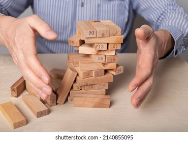 Business Crisis Concept With Wood Blocks Falling Down. High Quality Photo