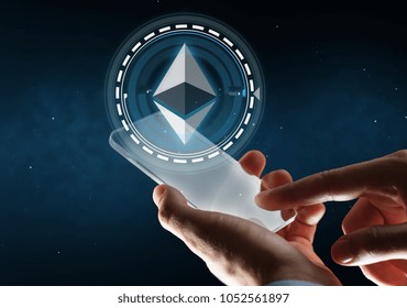 business, cryptocurrency and future technology concept - close up of businessman with transparent smartphone and virtual ethereum symbol hologram over space background - Powered by Shutterstock