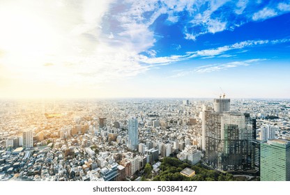 Business And Culture Concept - Panoramic Modern City Skyline Bird Eye Aerial View Under Dramatic Sun And Morning Blue Cloudy Sky In Tokyo, Japan