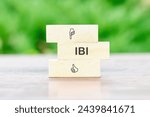 Business Customer Management Analysis Service. IBI on a wooden bar on a table on a green background