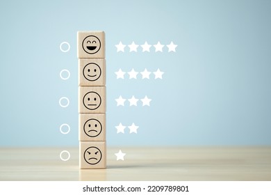 Business Or Customer Service Rating Experience And Feedback Emotion And Satisfaction And Mental Health Survey Concept. Wood Cube With Star And Negative, Neutral And Positive Facial Expressions.