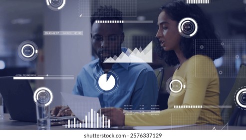 Business data analytics image over two colleagues discussing documents in office. discussion, strategy, teamwork, collaboration, meeting, planning