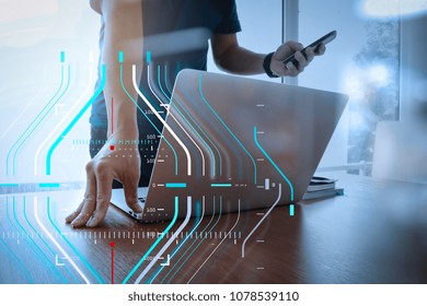 Business data analytics process management diagram.designer hand working and smart phone and laptop on wooden desk in office 
