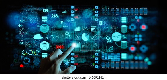 Business data analytics process management with businesswoman hand touching connected gear cogs with KPI financial charts and graph and automated marketing dashboard.