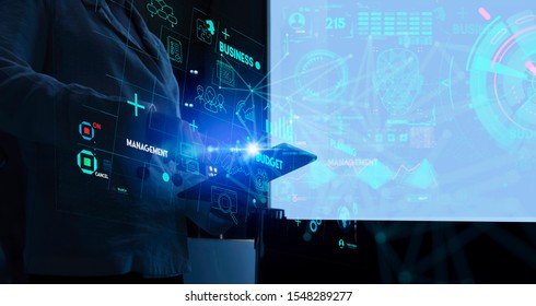 Business data analytics process management with businesswoman hand touching connected gear cogs with KPI financial charts and graph and automated marketing dashboard.