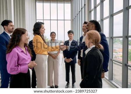 Business deal done and Commitment with hand shake by business team in seminar office room and other people crap the hand for celebrate this action.