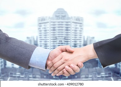 Business Deal With Handshake Over Big Tower.