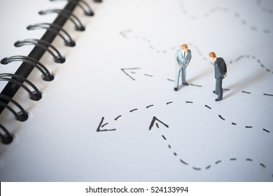 Business decision concept. Businessmen standing and giving advice with arrow pathway choice.