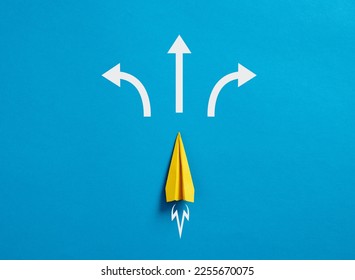 Business decision making and the way to success. Choosing a strategic path to move forward. Alternative options and business solutions. Paper plane with arrows pointing different directions. - Shutterstock ID 2255670075