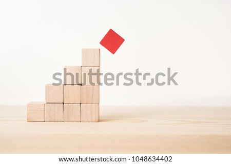 Business and design concept - abstract geometric real wooden cube pyramid on white floor background and it's not 3D render. It's the symbol of make a mistake, fall into a trap