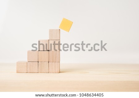 Business and design concept - abstract geometric real wooden cube pyramid on white floor background and it's not 3D render. It's the symbol of make a mistake, fall into a trap