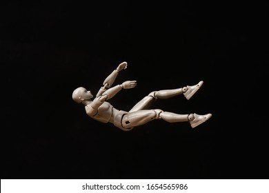 Business and design concept - falling mannequin isolated on black background. falling man - Powered by Shutterstock