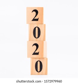 Business and design concept - geometric floating wooden cube on white background. 2020 year.
