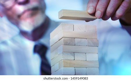 Business Development Concept By Building A Tower With Domino Blocks; Light Effect