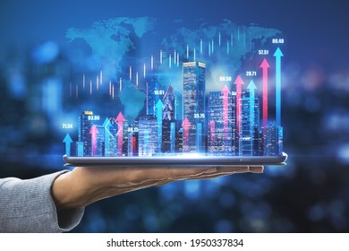 Business development concept with digital tablet on human palm with glowing night megapolis city skyline and vertical blue and pink growing arrows on world map with financial quotes background