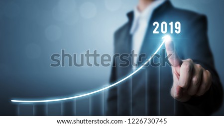 Business development to success in 2019 concept. Businessman pointing arrow graph corporate future growth plan