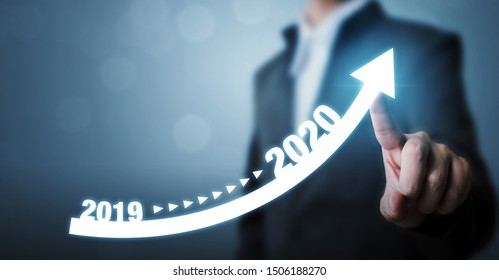 Business development to success and growing growth year 2019 to 2020 concept, Businessman pointing arrow graph corporate future growth plan