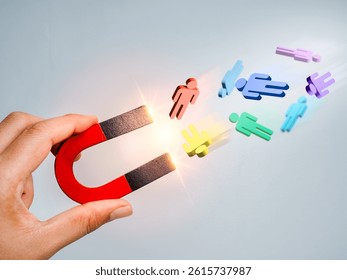 Business digital marketing, target audience, attract leads and customers concept. 3d human figure attracted by magnet in hand on grey background. Business team building, recruitment, hiring concepts.