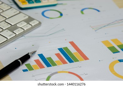 Business document Financial chart and graph.Computer keyboard and pen on paper work.